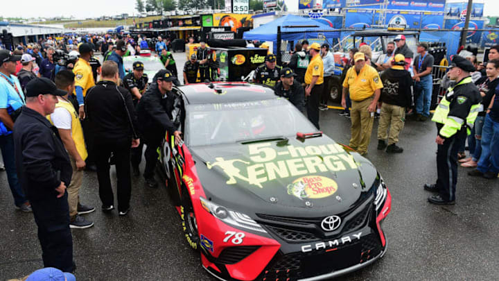 LOUDON, NH - JULY 22: Crew members push the #78 5-hour ENERGY/Bass Pro Shops Toyota, driven by Martin Truex Jr.(not pictured), to pit road following a rain delay prior to the Monster Energy NASCAR Cup Series Foxwoods Resort Casino 301 at New Hampshire Motor Speedway on July 22, 2018 in Loudon, New Hampshire. (Photo by Jared C. Tilton/Getty Images)