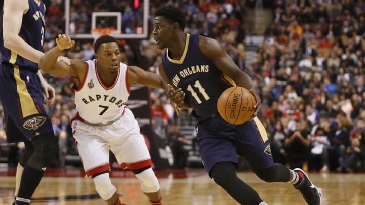 Nov 13, 2015; Toronto, Ontario, CAN; New Orleans Pelicans guard Jrue Holiday (11) dribbles around Toronto Raptors guard Kyle Lowry (7) during the first half at Air Canada Centre. Mandatory Credit: John E. Sokolowski-USA TODAY Sports