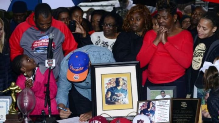 Feb 4, 2015; Glen Saint Mary, FL, USA; Ce Ce Jefferson signs with the University of Florida at his home near Baker County High School as his parents Leo and Annette Jefferson look on. Mandatory Credit: Richard Dole-USA TODAY Sports