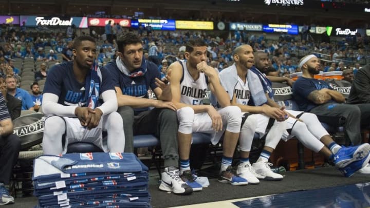Apr 21, 2016; Dallas, TX, USA; Dallas Mavericks guard Wesley Matthews (23) and center Zaza Pachulia (27) and center Salah Mejri (50) and guard Devin Harris (34) and guard Raymond Felton (2) and guard Deron Williams (8) watch from the bench during the second half against the Oklahoma City Thunder in game three of the first round of the NBA Playoffs at American Airlines Center. The Thunder defeated the Mavericks 131-102. Mandatory Credit: Jerome Miron-USA TODAY Sports