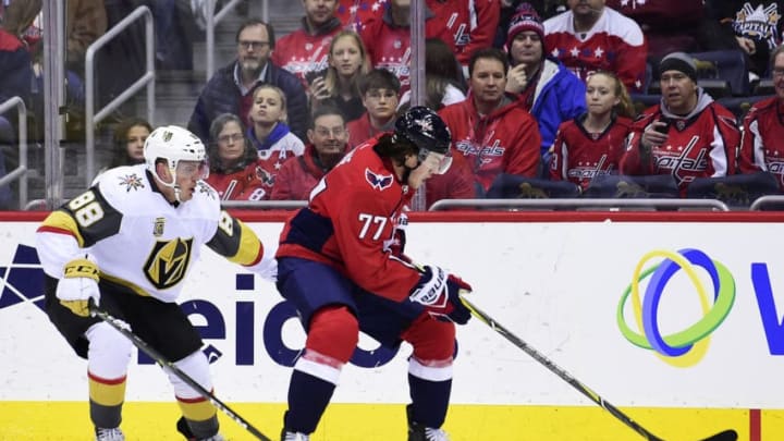 WASHINGTON, DC - FEBRUARY 04: T.J. Oshie #77 of the Washington Capitals controls the puck against Nate Schmidt #88 of the Vegas Golden Knights in the first period at Capital One Arena on February 4, 2018 in Washington, DC. (Photo by Patrick McDermott/NHLI via Getty Images)