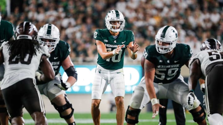 Michigan State quarterback Payton Thorne takes the snap from center Nick Samac (59) against Western Michigan during the second half at Spartan Stadium in East Lansing on Friday, Sept. 2, 2022.