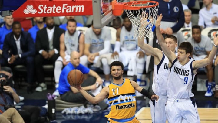 DALLAS, TX - APRIL 11: Jamal Murray #27 of the Denver Nuggets passes the ball in front of Nicolas Brussino #9 of the Dallas Mavericks at American Airlines Center on April 11, 2017 in Dallas, Texas. NOTE TO USER: User expressly acknowledges and agrees that, by downloading and/or using this photograph, user is consenting to the terms and conditions of the Getty Images License Agreement. (Photo by Ronald Martinez/Getty Images)