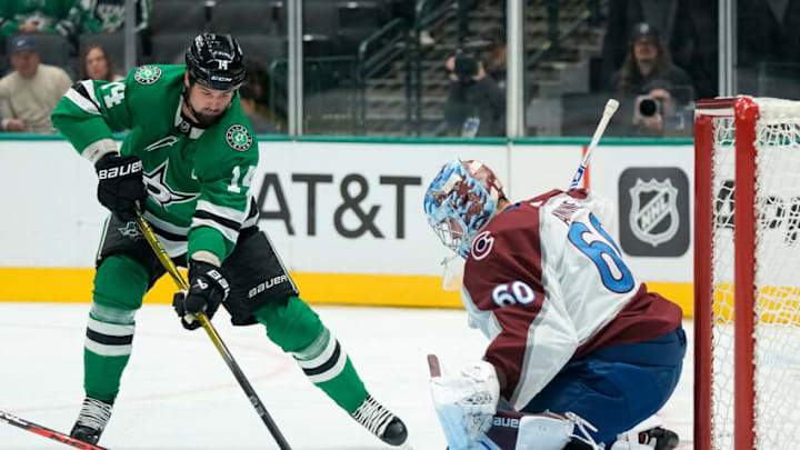 DALLAS, TEXAS - OCTOBER 03: Jamie Benn #14 of the Dallas Stars shoots the puck against Justus Annunen #60 of the Colorado Avalanche during the first period at American Airlines Center on October 03, 2023 in Dallas, Texas. (Photo by Sam Hodde/Getty Images)