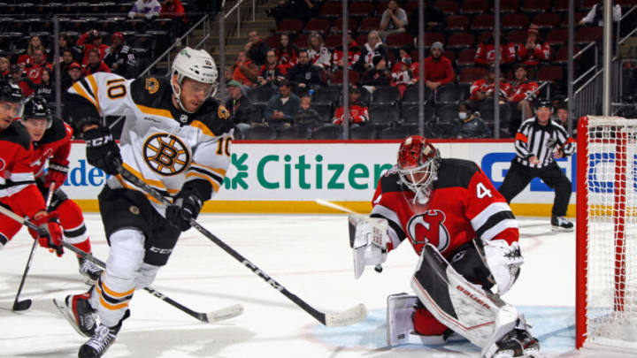 NEWARK, NEW JERSEY - OCTOBER 03: A.J. Greer #10 of the Boston Bruins is stopped by Vitek Vanecek #41 of the New Jersey Devils during the first period at the Prudential Center on October 03, 2022 in Newark, New Jersey. (Photo by Bruce Bennett/Getty Images)