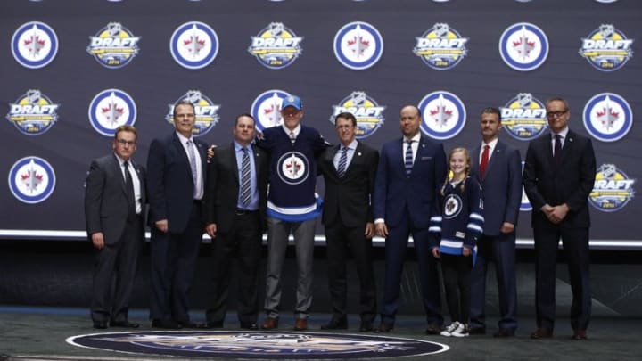 Jun 24, 2016; Buffalo, NY, USA; Patrik Laine poses for a photo with team officials after being selected as the number two overall draft pick by the Winnipeg Jets in the first round of the 2016 NHL Draft at the First Niagra Center. Mandatory Credit: Timothy T. Ludwig-USA TODAY Sports
