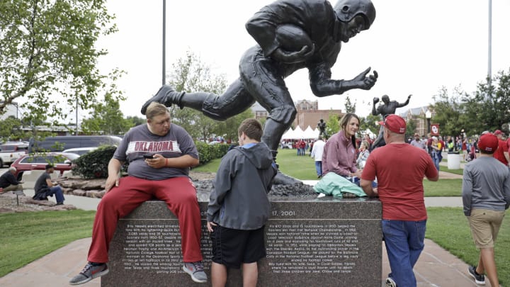 NORMAN, OK – Oklahoma Sooners fans wait on the statue of Heisman Trophy winner Billy Vessels before the game against the Army Black Knights at Gaylord Family Oklahoma Memorial Stadium on September 22, 2018 in Norman, Oklahoma. (Photo by Brett Deering/Getty Images)