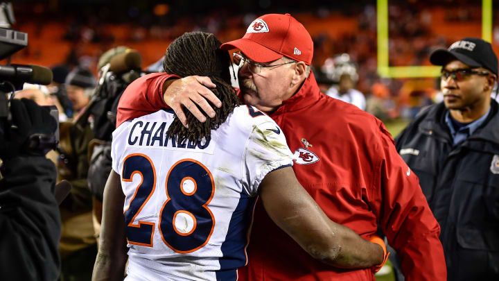 Head coach Andy Reid of the Kansas City Chiefs hugs his former player, and current running back of the Denver Broncos, Jamaal Charles #28 ( Photo by Jason Hanna/Getty Images )