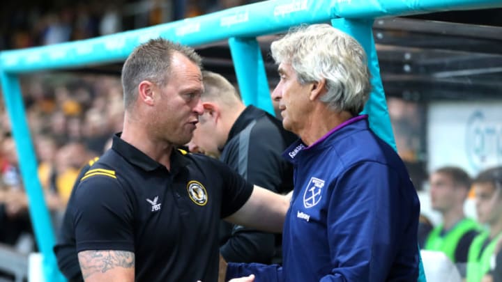 NEWPORT, WALES - AUGUST 27: Michael Flynn, Manager of Newport County shakes hands with Manuel Pellegrini, Manager of West Ham United prior to the Carabao Cup Second Round match between Newport County and West Ham United at Rodney Parade on August 27, 2019 in Newport, Wales. (Photo by Catherine Ivill/Getty Images)