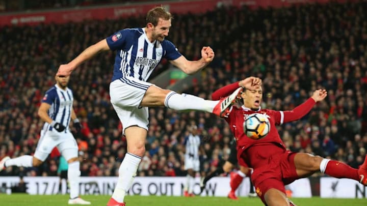 LIVERPOOL, ENGLAND - JANUARY 27: Craig Dawson of West Bromwich Albion takes a shot past Virgil van Dijk of Liverpool in the build up to an own goal scored by Joel Matip of Liverpool during The Emirates FA Cup Fourth Round match between Liverpool and West Bromwich Albion at Anfield on January 27, 2018 in Liverpool, England. (Photo by Alex Livesey/Getty Images)