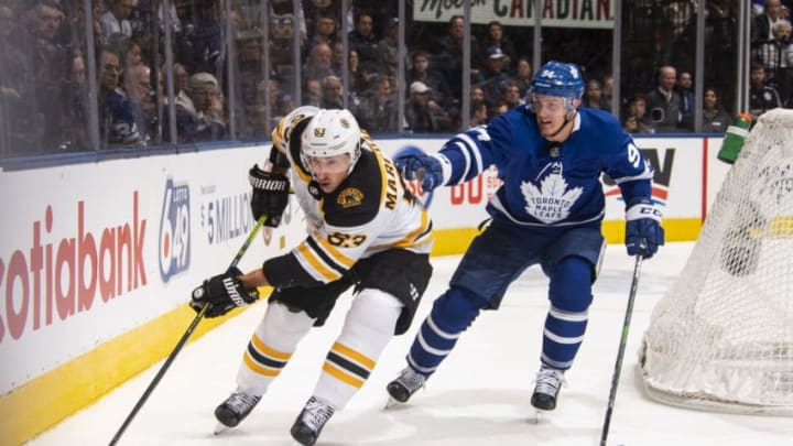 TORONTO, ON - OCTOBER 19: Tyson Barrie #94 of the Toronto Maple Leafs battles for the puck against Karson Kuhlman #83 of the Boston Bruins during the second period at the Scotiabank Arena on October 19, 2019 in Toronto, Ontario, Canada. (Photo by Mark Blinch/NHLI via Getty Images)
