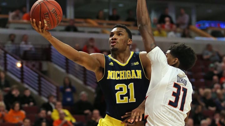 CHICAGO, IL – MARCH 12: Zak Irvin #21 of the Michigan Wolverines puts up a shot against Austin Colbert #31 of the Illinois Fighting Illini during the second round of the 2015 Big Ten Men’s Basketball Tournament at the United Center on March 12, 2015 in Chicago, Illinois. Michigan defeated Illinois 73-55. (Photo by Jonathan Daniel/Getty Images)