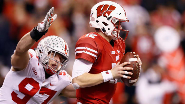 INDIANAPOLIS, IN – DECEMBER 02: Quarterback Alex Hornibrook #12 of the Wisconsin Badgers looks to pass against the defensive lineman Nick Bosa #97 of the Ohio State Buckeyes in the second half during the Big Ten Championship game at Lucas Oil Stadium on December 2, 2017 in Indianapolis, Indiana. (Photo by Andy Lyons/Getty Images)