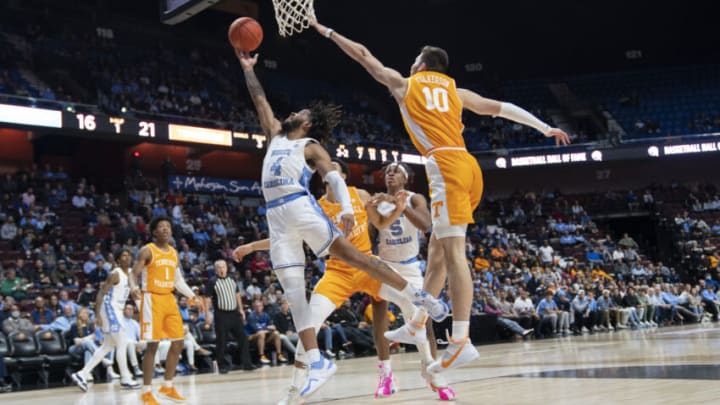 Nov 21, 2021; Uncasville, CT, USA; North Carolina Tarheels guard RJ Davis (4) shoots a layup with Tennessee Volunteers forward John Fulkerson (10) defending during the first half at Mohegan Sun Arena. Mandatory Credit: Gregory Fisher-USA TODAY Sports