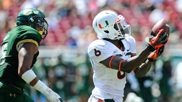 TAMPA, FL - SEPTEMBER 28: Wide receiver Herb Waters #6 of the Miami Hurricanes hauls in a pass in front of linebacker Reshard Cliett #16 of the South Florida Bulls during the third quarter on September 28, 2013 at Raymond James Stadium in Tampa, Florida. (Photo by Brian Blanco/Getty Images)