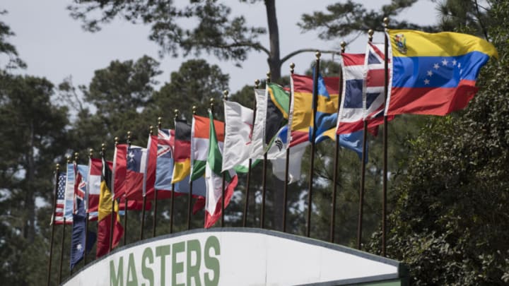 Apr 2, 2018; Augusta, GA, USA; A stiff breeze billows the flags atop the leaderboard during a practice round for the Masters golf tournament at Augusta National GC. Mandatory Credit: Michael Madrid-USA TODAY Sports