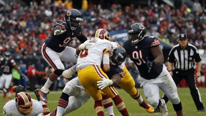 Dec 13, 2015; Chicago, IL, USA; Washington Redskins quarterback Kirk Cousins (8) is sacked by Chicago Bears outside linebacker Willie Young (97) linebacker Lamarr Houston (99) and nose tackle Eddie Goldman (91) during the first half at Soldier Field. Mandatory Credit: Kamil Krzaczynski-USA TODAY Sports
