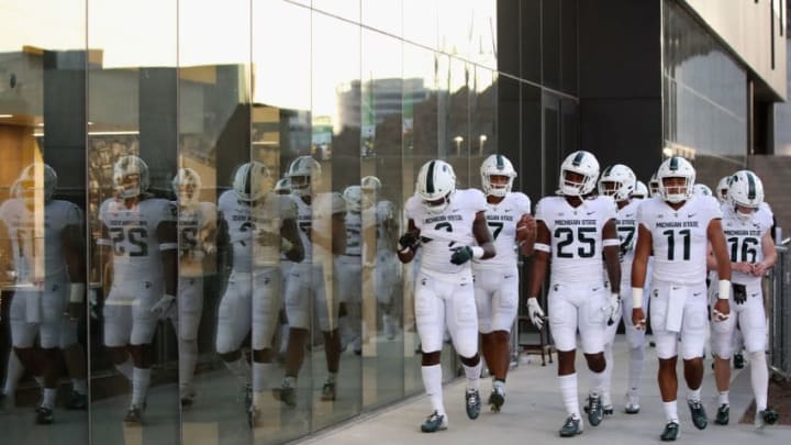 TEMPE, AZ - SEPTEMBER 08: Wide receiver Darrell Stewart Jr. #25 and running back Connor Heyward #11 of the Michigan State Spartans lead teammates out of the tunnell before the college football game against the Arizona State Sun Devils at Sun Devil Stadium on September 8, 2018 in Tempe, Arizona. (Photo by Christian Petersen/Getty Images)