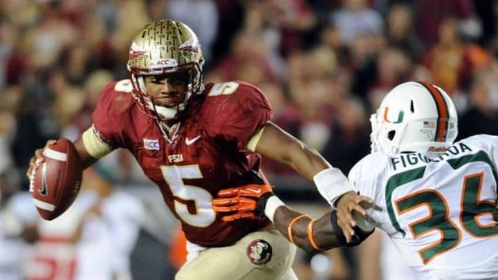 Nov 2, 2013; Tallahassee, FL, USA; Florida State Seminoles quarterback Jameis Winston (5) evades Miami Hurricanes linebacker Alex Figueroa (36) during the second half at Doak Campbell Stadium. Mandatory Credit: Melina Vastola-USA TODAY Sports