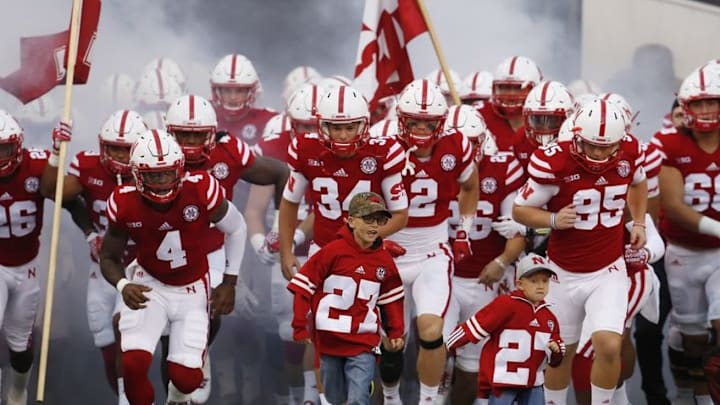 Sep 3, 2016; Lincoln, NE, USA; Nebraska Cornhuskers players run onto the field with the nephews, Lane Foltz (left) and Max Folz (right), of deceased punter Sam Folz prior to the game against the Fresno State Bulldogs in the first quarter at Memorial Stadium. Folz was killed in a car crash July 23, 2016. Nebraska won 43-10. Mandatory Credit: Bruce Thorson-USA TODAY Sports
