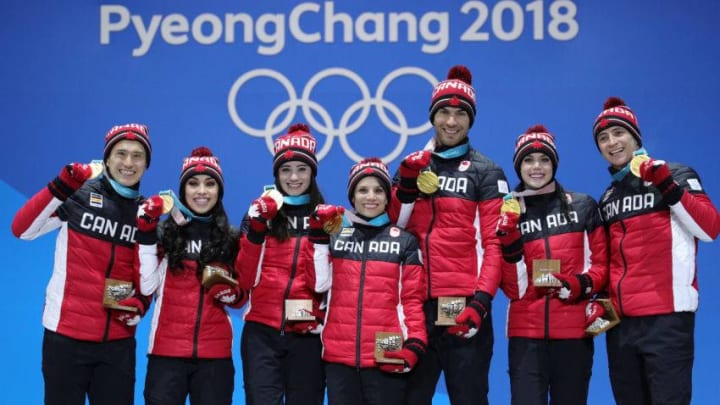 PYEONGCHANG-GUN, SOUTH KOREA - FEBRUARY 12: Gold medalists (L-R) Patrick Chan, Gabrielle Daleman, Kaetlyn Osmond, Meagan Duhamel, Eric Radford, Tessa Virtue and Scott Moir of Team Canada celebrate during the medal ceremony after the Figure Skating Team Event at Medal Plaza on February 12, 2018 in Pyeongchang-gun, South Korea. (Photo by Andreas Rentz/Getty Images)