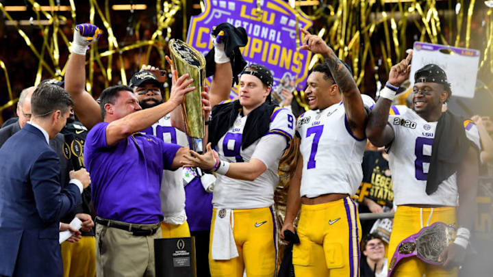 NEW ORLEANS, LOUISIANA - JANUARY 13: Head coach Ed Orgeron of the LSU Tigers raises the National Championship Trophy with Joe Burrow #9, Grant Delpit #7, and Patrick Queen #8 after the College Football Playoff National Championship game at the Mercedes Benz Superdome on January 13, 2020 in New Orleans, Louisiana. The LSU Tigers topped the Clemson Tigers, 42-25. (Photo by Alika Jenner/Getty Images)