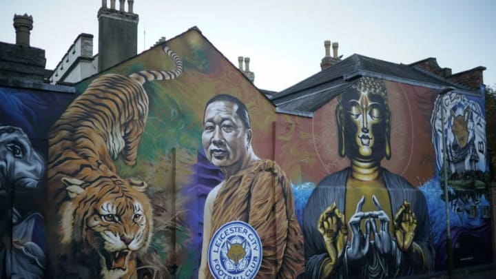 LEICESTER, ENGLAND - OCTOBER 29: People walk past a mural dedicated to Leicester City Football Club and Buddhist monk Phra Prommangkalachan on October 28, 2018 in Leicester, England. The city of Leicester is in mourning after Leicester City's Thai chairman Vichai Srivaddhanaprabha died in a helicopter crash alongside four others at the club's King Power Stadium on Saturday. (Photo by Christopher Furlong/Getty Images)