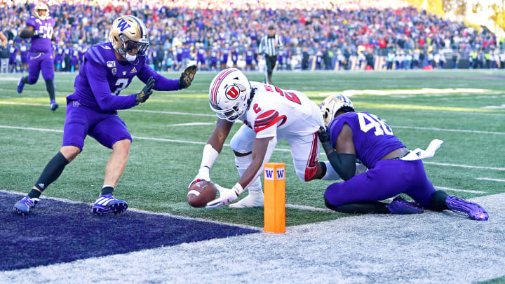 SEATTLE, WASHINGTON – NOVEMBER 02: Zack Moss #2 of the Utah Utes scores on a 9 yard pass from Tyler Huntley #1during the second half of the game at Husky Stadium on November 02, 2019 in Seattle, Washington. (Photo by Alika Jenner/Getty Images)