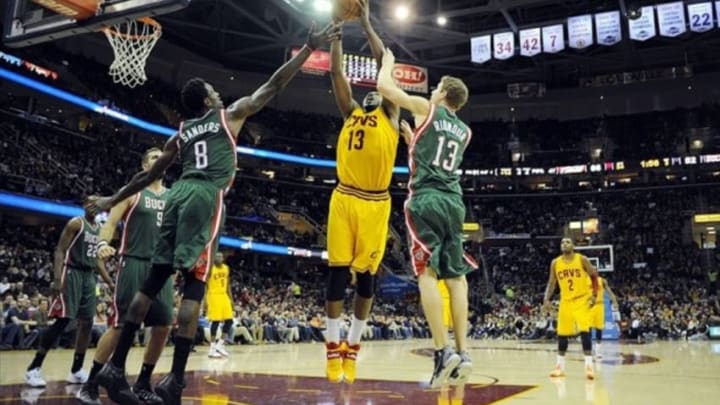 Jan 24, 2014; Cleveland, OH, USA; Cleveland Cavaliers forward Tristan Thompson (13) fights for a rebound with Milwaukee Bucks guard Luke Ridnour (13) and Milwaukee Bucks center Larry Sanders (8) during the third quarter at Quicken Loans Arena. The Cavaliers beat the Bucks 93-78. Mandatory Credit: Ken Blaze-USA TODAY Sports