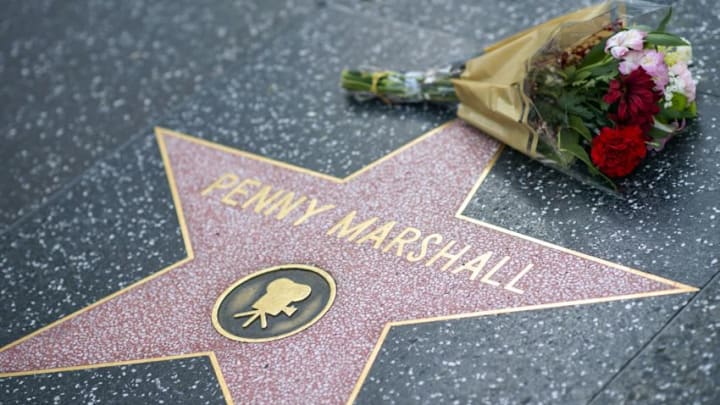 Fans leave tributes on Penny Marshall's star on the Hollywood Walk of Fame shortly after the news that the actress died aged 75 was made public, in Hollywood, California, on December 18, 2018. - Penny Marshall, the star of ABC's "Laverne and Shirley" who became one of the most successful female directors in history at the helm of "Big," "A League of Their Own" and a string of other hit movies, has died. She was 75. The filmmaker died peacefully in her Hollywood Hills on Monday, December 17, 2018 due to complications from diabetes, her publicist told AFP. (Photo by VALERIE MACON / AFP) (Photo credit should read VALERIE MACON/AFP/Getty Images)