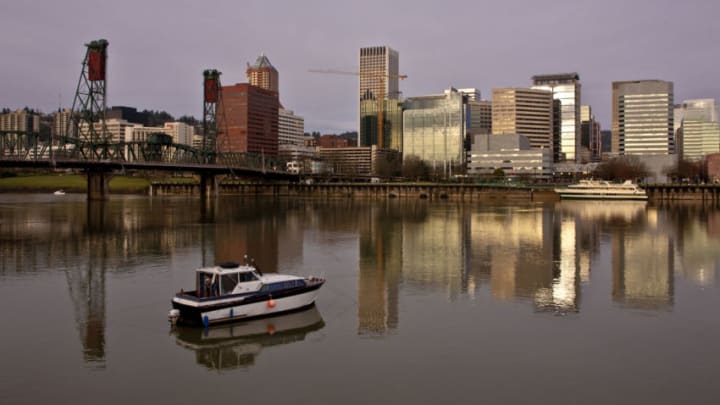 PORTLAND, OR - FEBRUARY 11: The downtown skyline is reflected in the flowing Willamette River on February 11, 2012 in Portland, Oregon. Portland has embraced its national reputation as a city inhabited with weird, independent people, as underscored by the dark comedy of the IFC TV show "Portlandia." (Photo by George Rose/Getty Images)