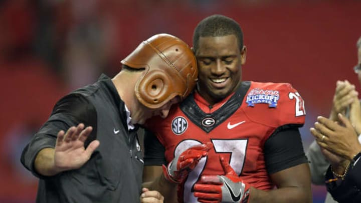 Sep 3, 2016; Atlanta, GA, USA; Georgia Bulldogs head coach Kirby Smart puts on the Old Leather Helmet and reacts with running back Nick Chubb (27) after the 2016 Chick-Fil-A Kickoff game against the North Carolina Tar Heels at Georgia Dome. Georgia won 33-24. Mandatory Credit: Dale Zanine-USA TODAY Sports