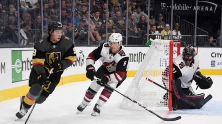 LAS VEGAS, NEVADA – SEPTEMBER 15: Cody Glass #9 of the Vegas Golden Knights skates with the puck against Jakob Chychrun #6 of the Arizona Coyotes as Adin Hill #31 of the Coyotes tends net in the second period of their preseason game at T-Mobile Arena on September 15, 2019 in Las Vegas, Nevada. The Golden Knights defeated the Coyotes 6-2. (Photo by Ethan Miller/Getty Images)