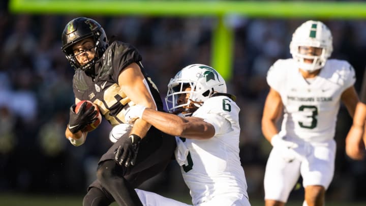 Nov 6, 2021; West Lafayette, Indiana, USA; Purdue Boilermakers wide receiver Jackson Anthrop (33) runs the ball while Michigan State Spartans linebacker Quavaris Crouch (6) defends in the first half at Ross-Ade Stadium. Mandatory Credit: Trevor Ruszkowski-USA TODAY Sports