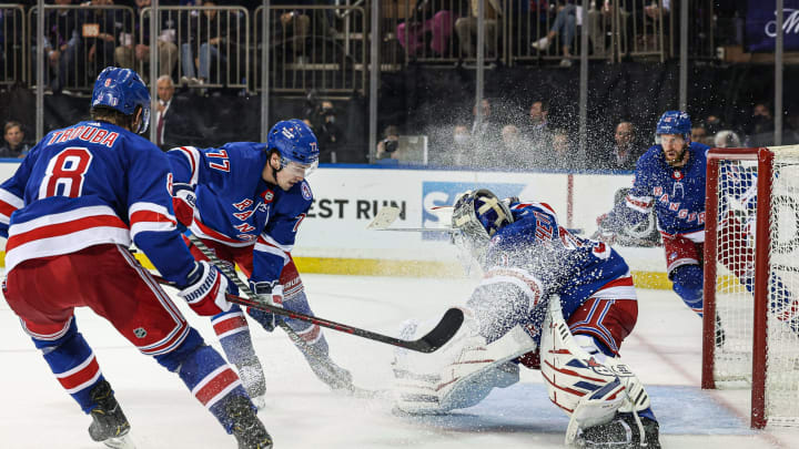 May 3, 2022; New York, New York, USA; New York Rangers goaltender Igor Shesterkin (31) makes a save in front of center Frank Vatrano (77) and defenseman Jacob Trouba (8) during the third period against the Pittsburgh Penguins in game one of the third round of the 2022 Stanley Cup Playoffs at Madison Square Garden. Mandatory Credit: Vincent Carchietta-USA TODAY Sports