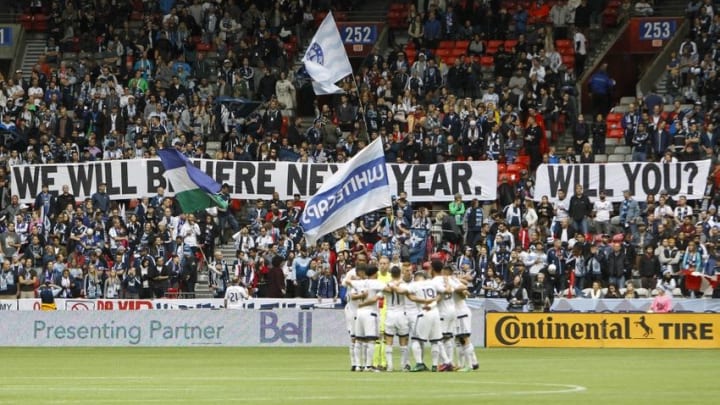 Oct 23, 2016; Vancouver, British Columbia, CAN; Vancouver Whitecaps FC starters huddle before kickoff against the Portland Timbers as their fans display a tifo in the background at BC Place. Vancouver defeated Portland, 4-1. Mandatory Credit: Joe Nicholson-USA TODAY Sports