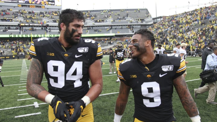 IOWA CITY, IOWA- OCTOBER 19: Defensive end A.J. Epenesa #94 and defensive back Geno Stone #9 of the Iowa Hawkeyes walk off the field together following their match-up against the Purdue Boilermakers on October 19, 2019 at Kinnick Stadium in Iowa City, Iowa. (Photo by Matthew Holst/Getty Images)