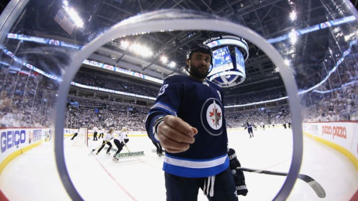 WINNIPEG, MB - MAY 12: Dustin Byfuglien #33 of the Winnipeg Jets picks up debris off the ice during a third period stoppage in play against the Vegas Golden Knights in Game One of the Western Conference Final during the 2018 NHL Stanley Cup Playoffs at the Bell MTS Place on May 12, 2018 in Winnipeg, Manitoba, Canada. (Photo by Darcy Finley/NHLI via Getty Images)