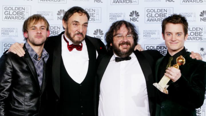BEVERLY HILLS, CA - JANUARY 25: Cast members of "Lord of the Rings: The Return of the King" (L-R) Dominic Monaghan, John Rhys-Davies, director Peter Jackson and Elijah Wood with their award for Best Motion Picture-Drama pose backstage at the 61st Annual Golden Globe Awards at the Beverly Hilton Hotel on January 25, 2004 in Beverly Hills, California. (Photo by Kevin Winter/Getty Images)