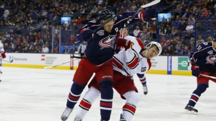 Nov 4, 2014; Columbus, OH, USA; Columbus Blue Jackets defenseman Jack Johnson (7) checks Carolina Hurricanes left wing Jiri Tlusty (19) during the first period at Nationwide Arena. Mandatory Credit: Russell LaBounty-USA TODAY Sports