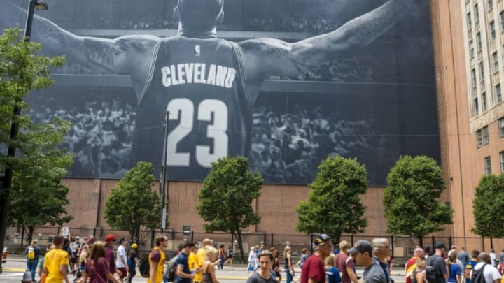 CLEVELAND, OH - JUNE 22: Cleveland fans walk in front of a LeBron James mural located on Ontario St. during the Cleveland Cavaliers 2016 NBA Championship victory parade and rally on June 22, 2016 in Cleveland, Ohio. The Cavaliers defeated the Golden State Warriors to bring the first professional sports championship to the city of Cleveland since 1964. (Photo by Angelo Merendino/Getty Images)