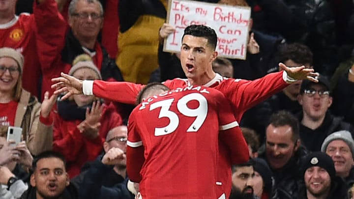 Manchester United's Portuguese striker Cristiano Ronaldo (R) celebrates with Manchester United's Scottish midfielder Scott McTominay after scoring their third goal during the English Premier League football match between Manchester United and Burnley at Old Trafford in Manchester, north-west England, on December 30, 2021. - RESTRICTED TO EDITORIAL USE. No use with unauthorized audio, video, data, fixture lists, club/league logos or 'live' services. Online in-match use limited to 120 images. An additional 40 images may be used in extra time. No video emulation. Social media in-match use limited to 120 images. An additional 40 images may be used in extra time. No use in betting publications, games or single club/league/player publications. (Photo by Oli SCARFF / AFP) / RESTRICTED TO EDITORIAL USE. No use with unauthorized audio, video, data, fixture lists, club/league logos or 'live' services. Online in-match use limited to 120 images. An additional 40 images may be used in extra time. No video emulation. Social media in-match use limited to 120 images. An additional 40 images may be used in extra time. No use in betting publications, games or single club/league/player publications. / RESTRICTED TO EDITORIAL USE. No use with unauthorized audio, video, data, fixture lists, club/league logos or 'live' services. Online in-match use limited to 120 images. An additional 40 images may be used in extra time. No video emulation. Social media in-match use limited to 120 images. An additional 40 images may be used in extra time. No use in betting publications, games or single club/league/player publications. (Photo by OLI SCARFF/AFP via Getty Images)