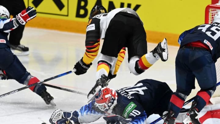Germany's forward Markus Eisenschmid (top, C) vies with US' goalkeeper Calvin Petersen during the IIHF Men's Ice Hockey World Championships preliminary round group B match between United States and Germany, at the Arena Riga in Riga, on May 31, 2021. (Photo by Gints IVUSKANS / AFP) (Photo by GINTS IVUSKANS/AFP via Getty Images)