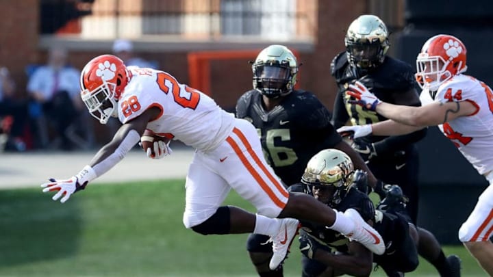 WINSTON SALEM, NC - OCTOBER 06: Tavien Feaster #28 of the Clemson Tigers is stopped by the defense of the Wake Forest Demon Deacons during their game at BB&T Field on October 6, 2018 in Winston Salem, North Carolina. (Photo by Streeter Lecka/Getty Images)