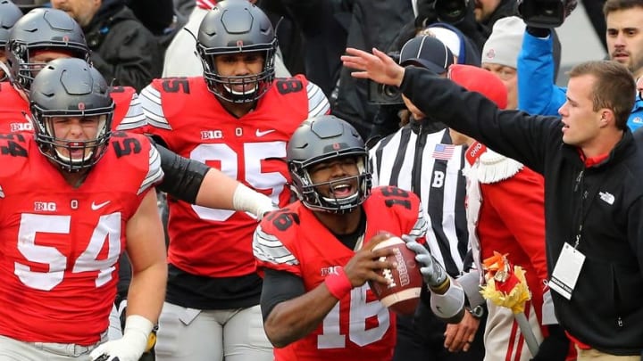 Nov 26, 2016; Columbus, OH, USA; Ohio State Buckeyes quarterback J.T. Barrett (16) celebrates his touchdown with teammate Ohio State Buckeyes offensive lineman Billy Price (54) during the first overtime against the Michigan Wolverines at Ohio Stadium. Ohio State won 30-27. Mandatory Credit: Joe Maiorana-USA TODAY Sports