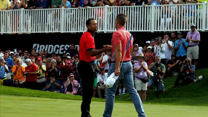 Aug 4, 2013; Akron, OH, USA; Tiger Woods (left) shakes hands with Henrik Stenson after winning the final round of the World Golf Championships – Bridgestone Invitational at Firestone Country Club. Mandatory Credit: Debby Wong-USA TODAY Sports