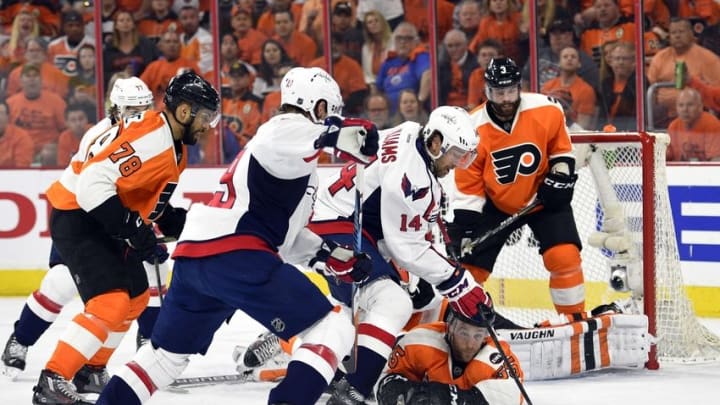 Apr 24, 2016; Philadelphia, PA, USA; Washington Capitals right wing Justin Williams (14) attempts to shoot the puck as Philadelphia Flyers defenseman Nick Schultz (55) falls to the ice during the first period in game six of the first round of the 2016 Stanley Cup Playoffs at Wells Fargo Center. Mandatory Credit: Derik Hamilton-USA TODAY Sports