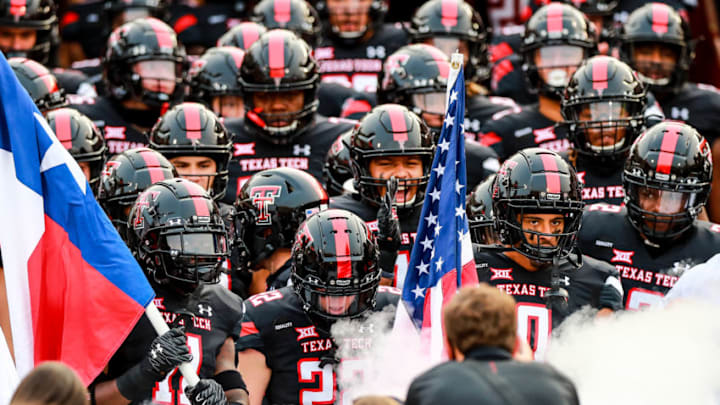 LUBBOCK, TEXAS - SEPTEMBER 12: Defensive back Eric Monroe #11, receiver Sterling Galban #22, and receiver Seth Collins #0 of the Texas Tech Red Raiders lead their teammates onto the field before the college football game against the Houston Baptist Huskies on September 12, 2020 at Jones AT&T Stadium in Lubbock, Texas. (Photo by John E. Moore III/Getty Images)