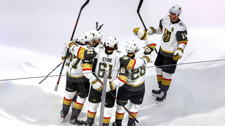 Mark Stone #61 of the Vegas Golden Knights is congratulated by his teammates after scoring a goal against the Vancouver Canucks