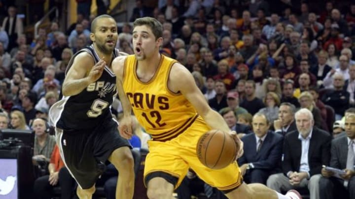 Nov 19, 2014; Cleveland, OH, USA; Cleveland Cavaliers guard Joe Harris (12) drives against San Antonio Spurs guard Tony Parker (9) in the second quarter at Quicken Loans Arena. Mandatory Credit: David Richard-USA TODAY Sports